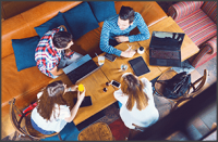 Group of young people sitting at a cafe, top view