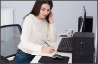 a woman sits at her home office