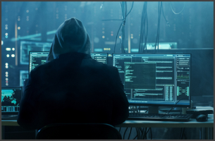 Hacker sitting in front of a computer