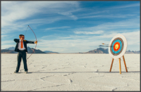 boy shoots arrow at a target
