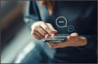Woman holding a phone sending a chat message