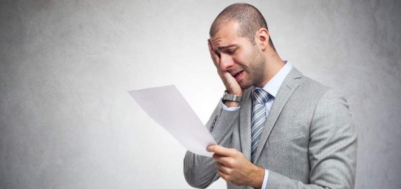 Hacking Schemes: Depressed man reading a document