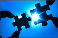 Two hands trying to connect puzzle