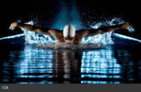 Competitive male swimmer swimming butterfly stroke.